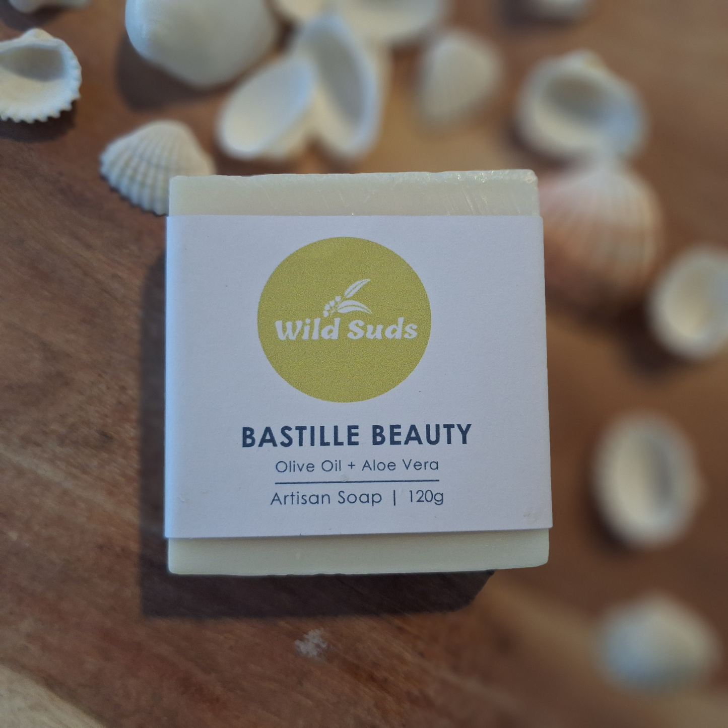 Olive oil soap with cigar band label on wooden tray with white shells