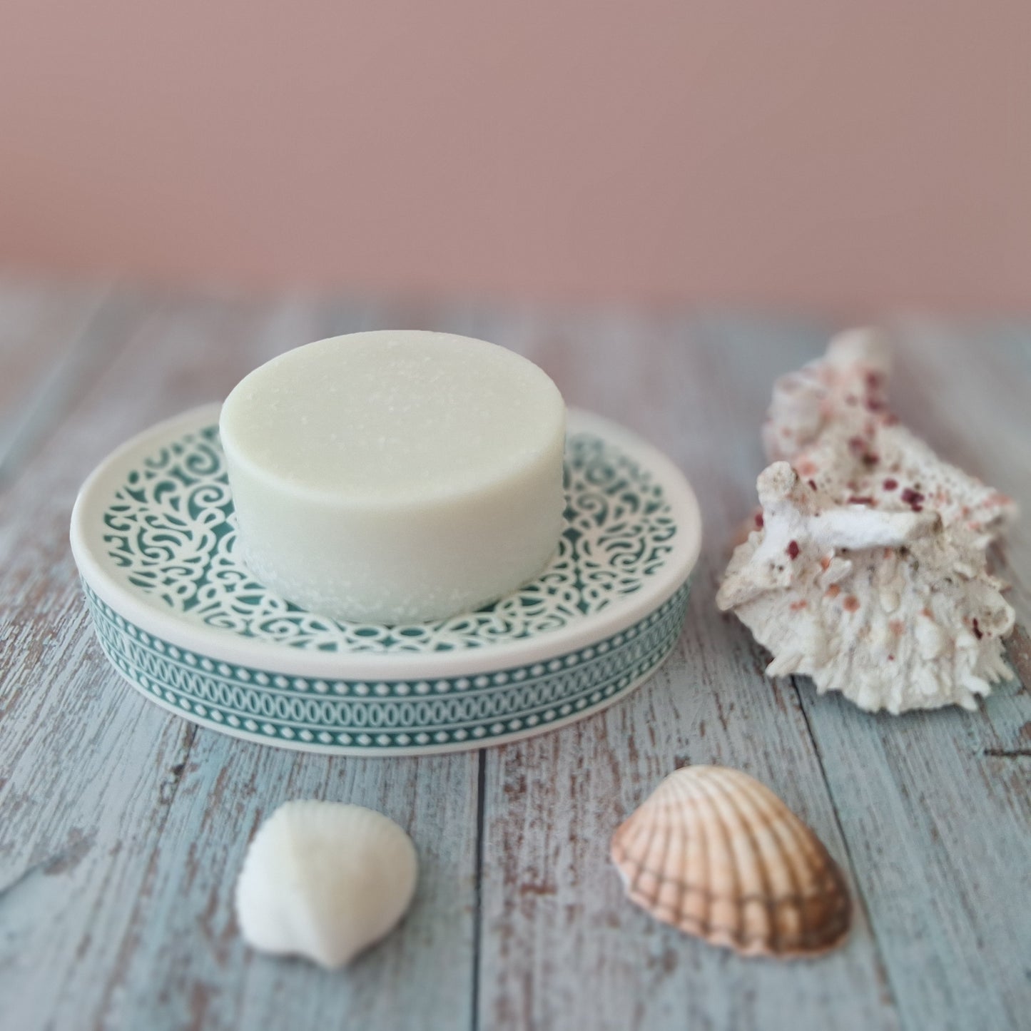 lime patchouli salt soap on green coastal soap holder surrounded by shells